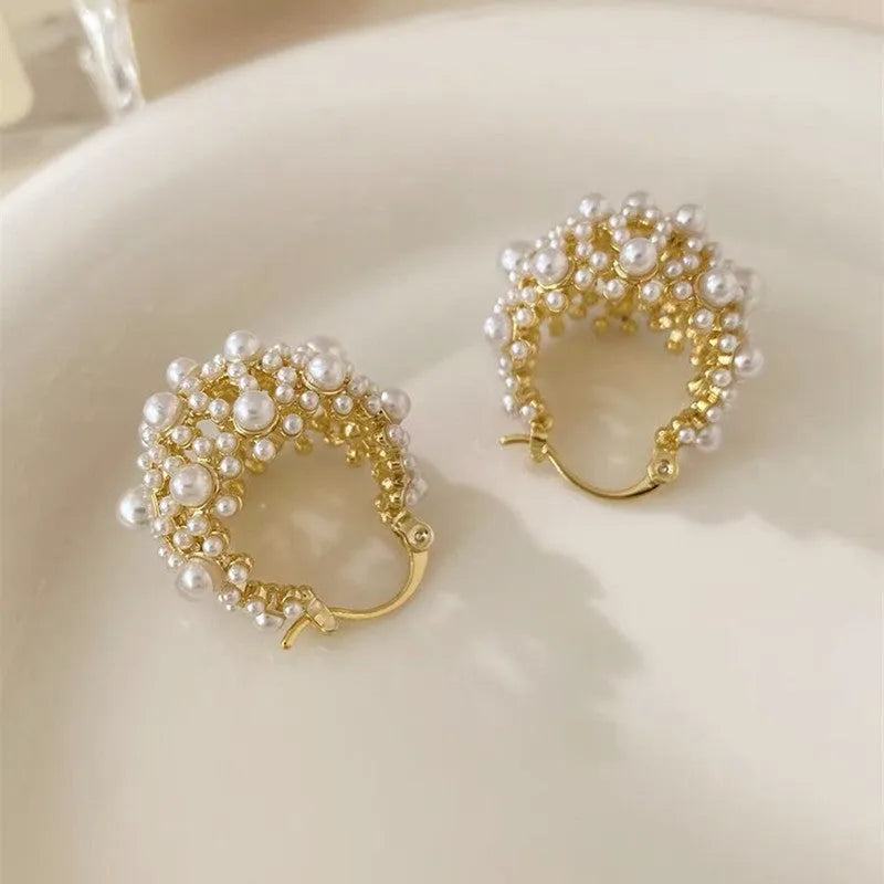 Gold copper flower basket earrings with small rice-shaped bead decoration and pearl inlay.