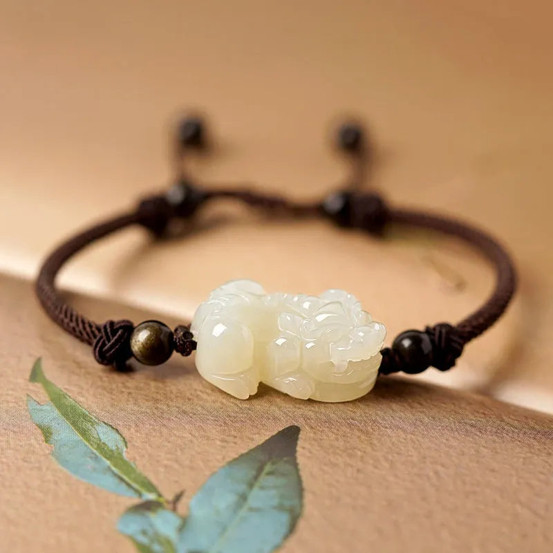 Hetian Jade bracelet with a black and red braided rope band and a central jade bead.