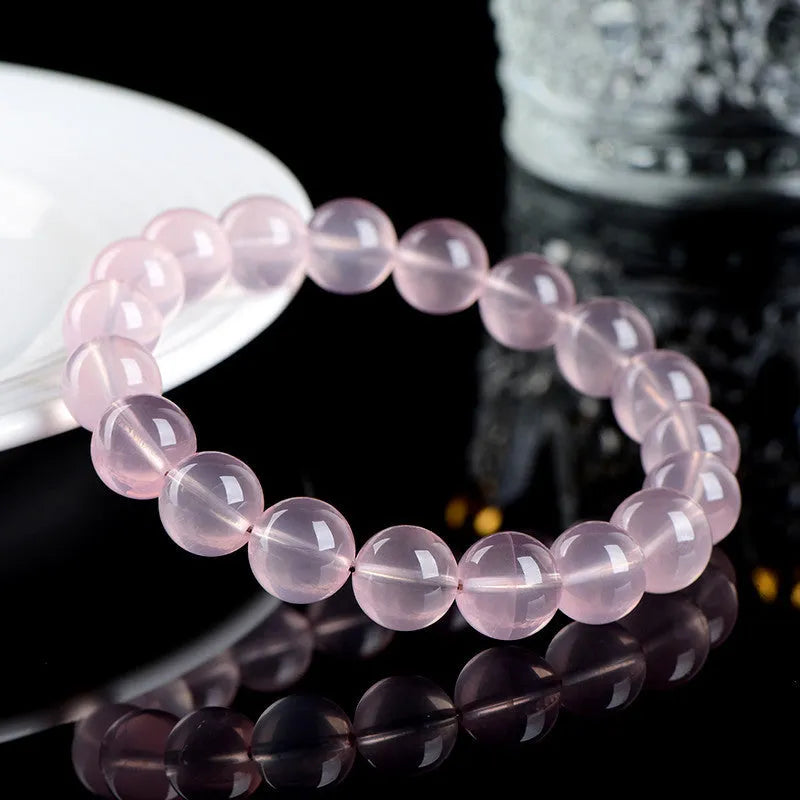 Women's polished crystal round bead bracelet in pink, showing single circle design with various size options.
