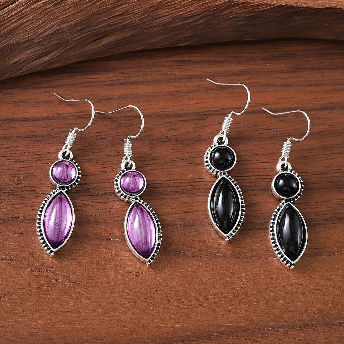 Geometric vintage pendant earrings with black and purple electroplated finish and round elements