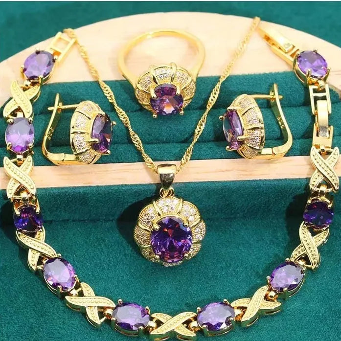 Gold plated jewellery set with multi-colour cubic zirconia stones, featuring a necklace, earrings, a ring, and a bracelet.
