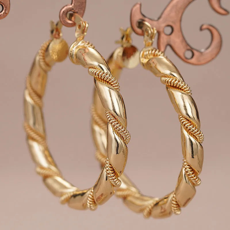 Geometric copper earrings with ring and line design in a gold colour.