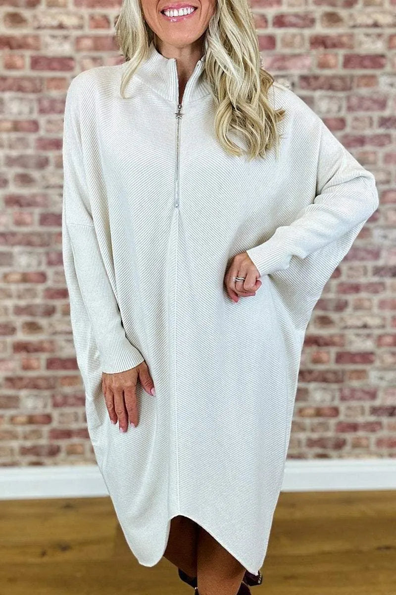 Women's loose-fit knitted dress in navy blue with a front zip closure and raglan sleeves.