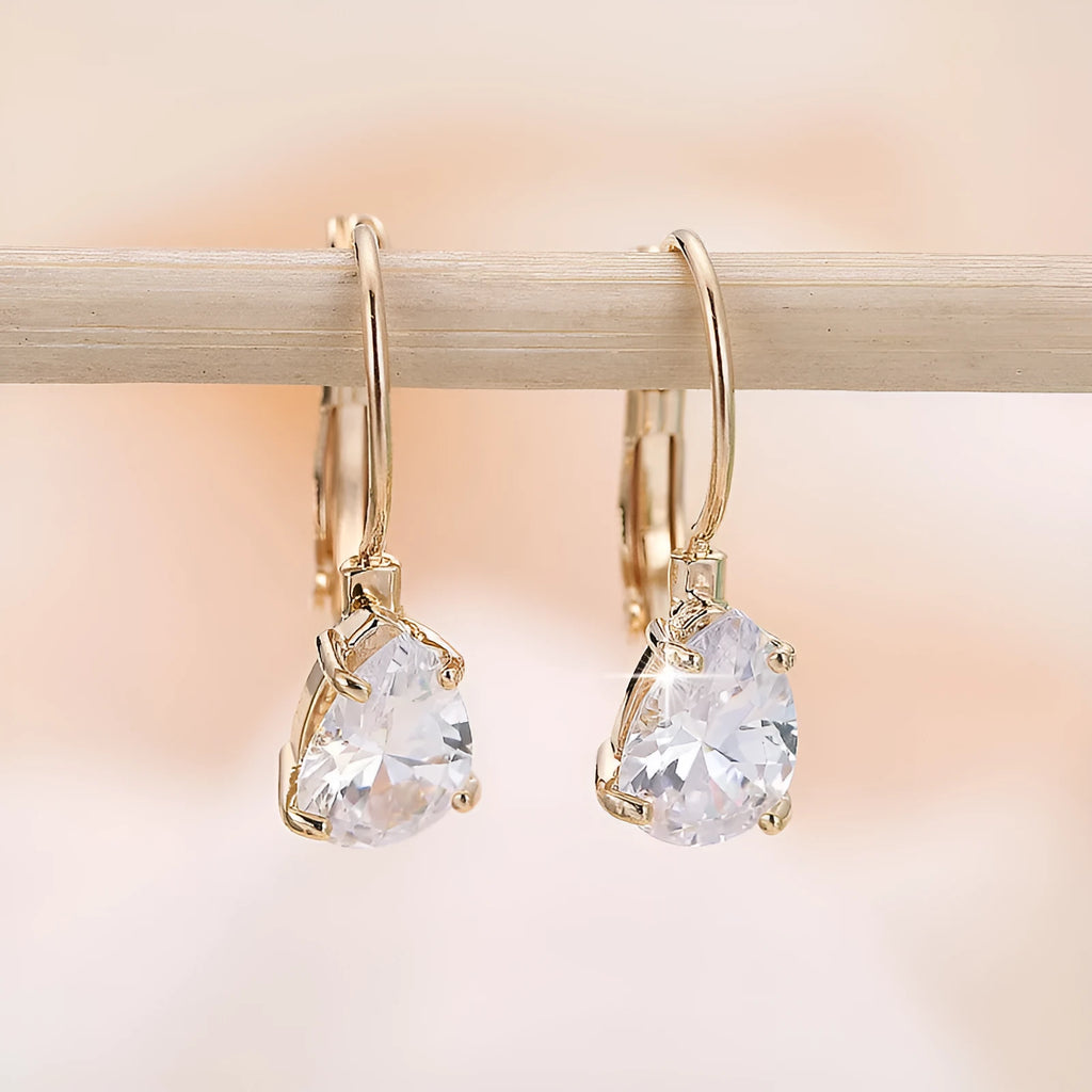 Drop-shaped metal earrings with platinum gem details in gold or platinum colour options