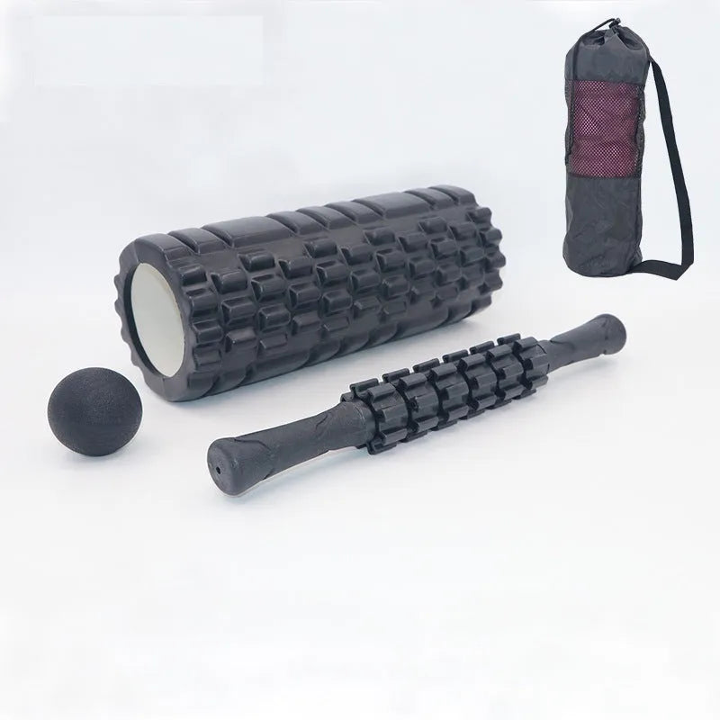 Black 33cm fitness foam roller with six gear massage bar pieces on grey background