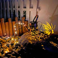Solar garden lamp with tapered butterfly silhouette design in iron construction
