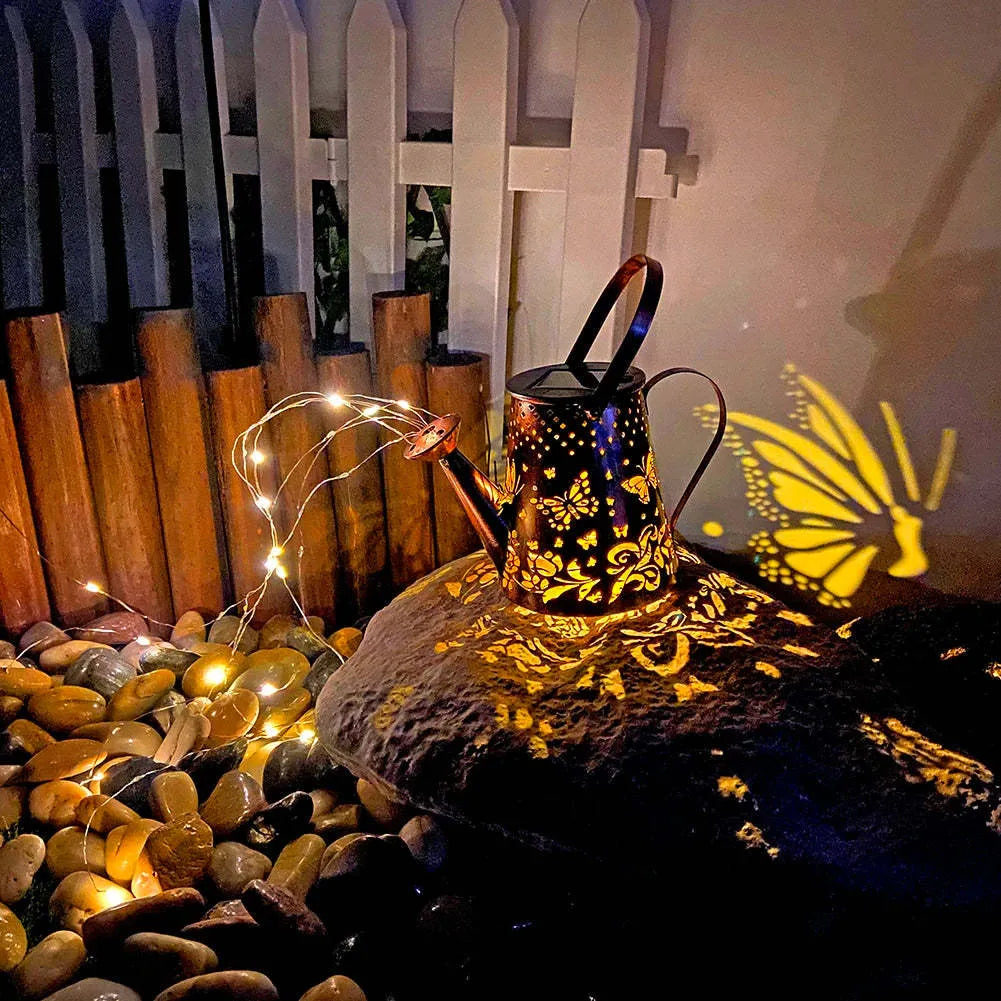 Solar garden lamp with tapered butterfly silhouette design in iron construction