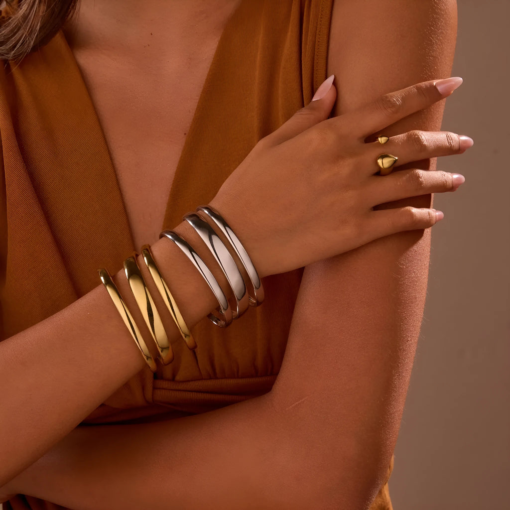 A geometric line design stainless steel bracelet with a simple opening clasp, shown in a gold electroplated finish.