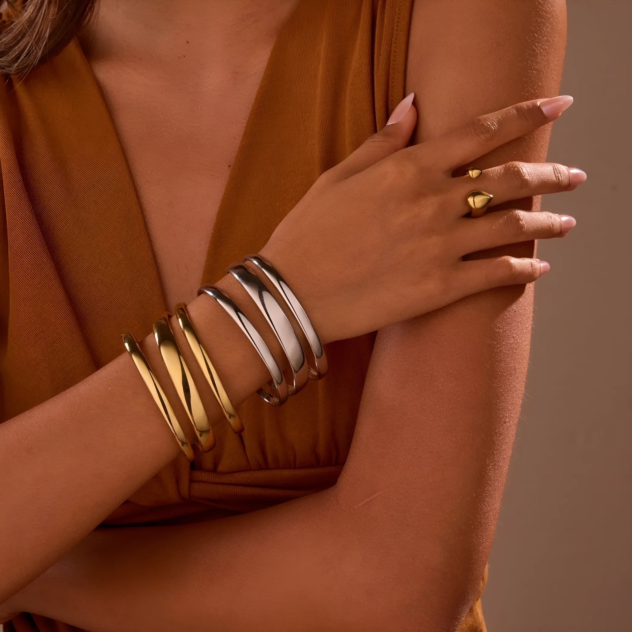 A geometric line design stainless steel bracelet with a simple opening clasp, shown in a gold electroplated finish.