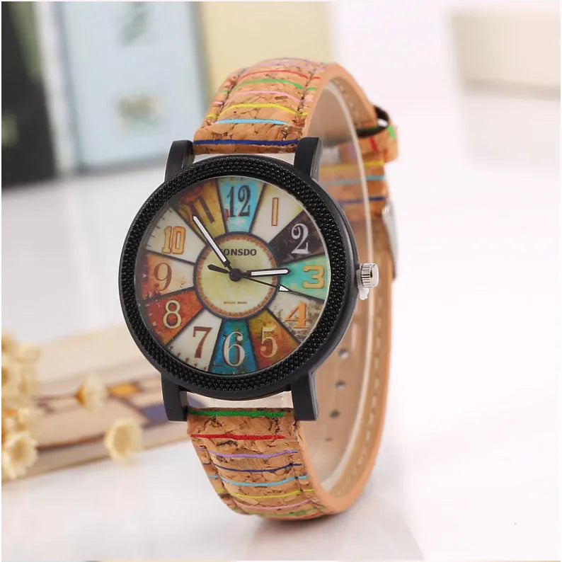Vintage style women's leather strap quartz watch with round 37mm dial and stainless steel buckle.