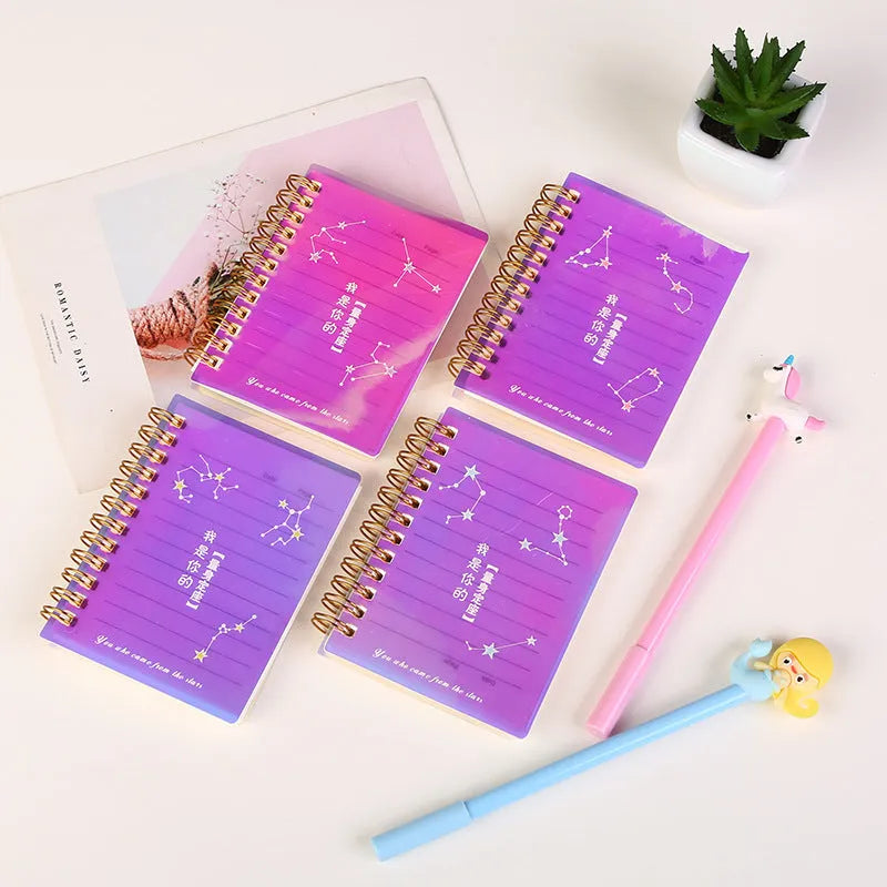 Set of four A7 spiral notebooks with different coloured covers showing constellation, cherry blossom, ocean, and universe designs.