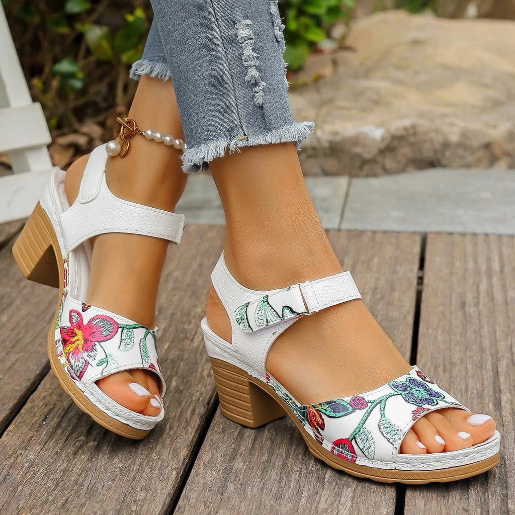 White women's high heel sandals showing the velcro buckle fastening on the strap.