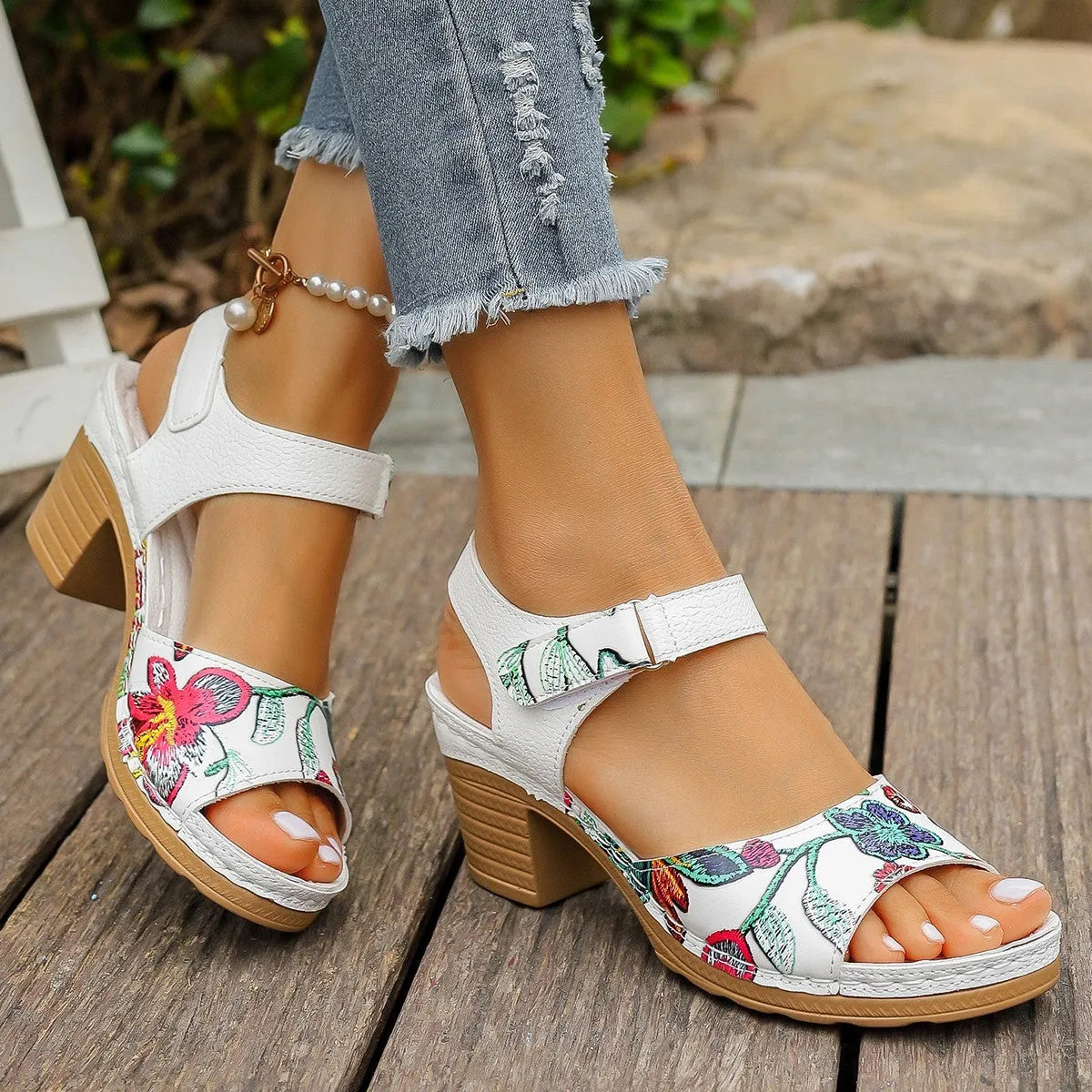 White women's high heel sandals showing the velcro buckle fastening on the strap.