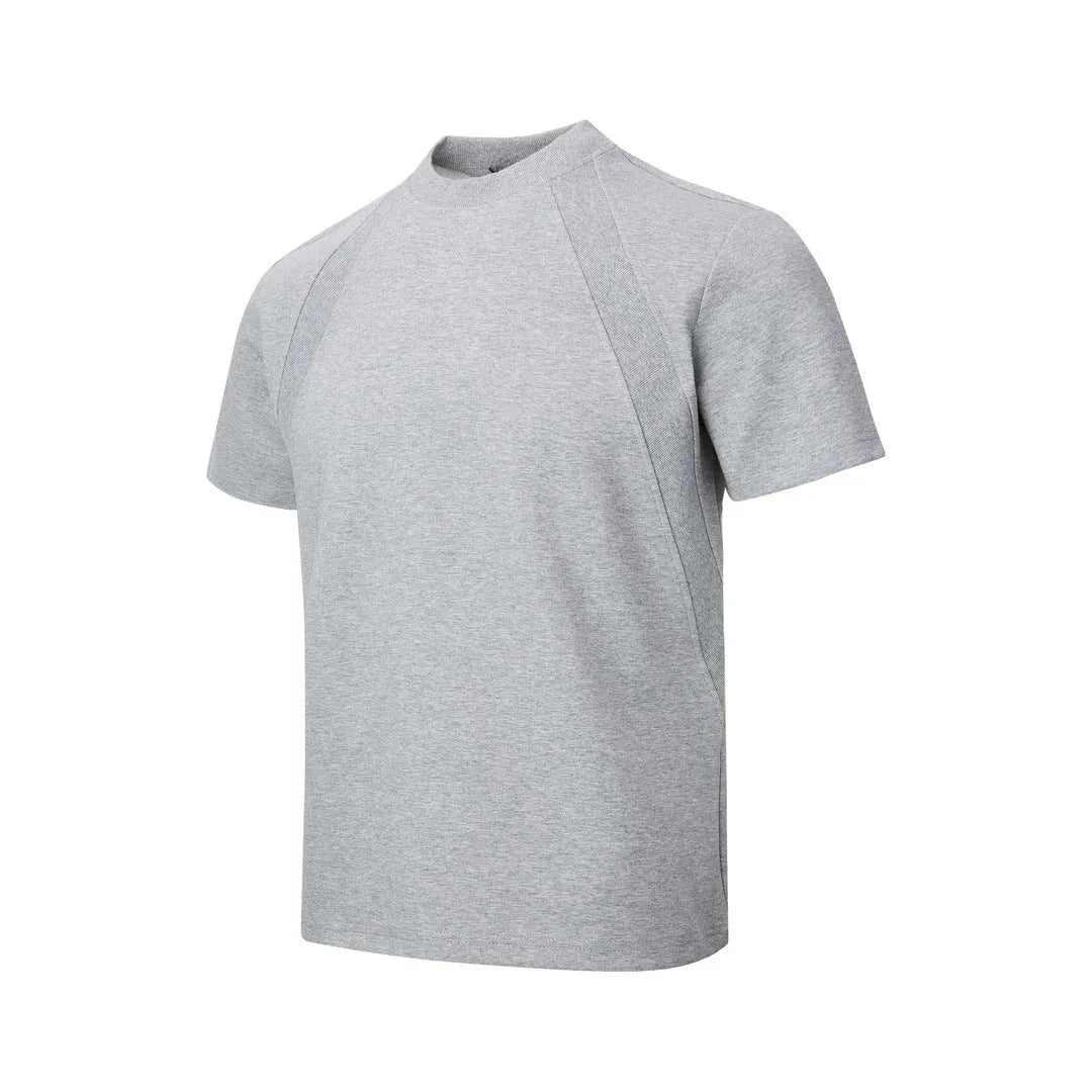 Man wearing a black loose-fit short sleeve top with visible air layer stitching texture.