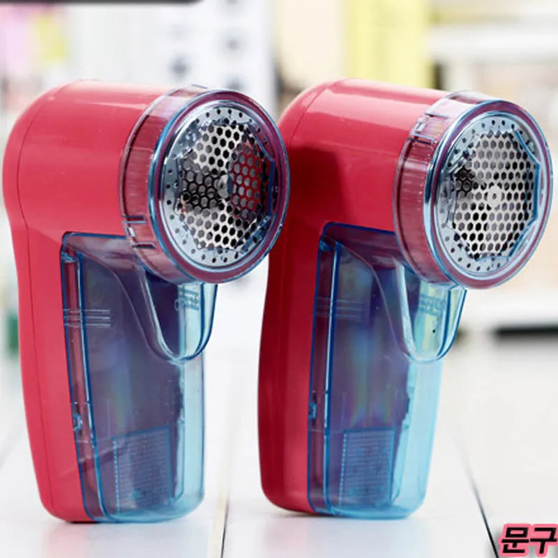 White portable electric lint remover for clothing, showing compact size and USB-C charging port.
