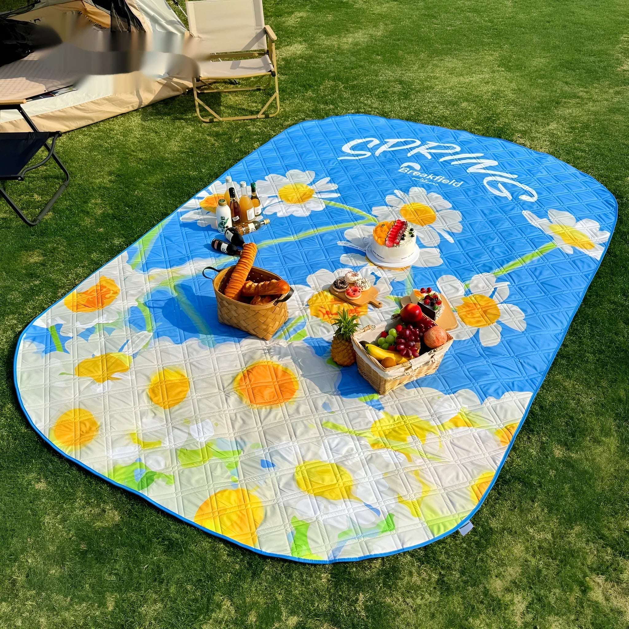 Large waterproof picnic mat in a seasonal colour on grass, showing its size for a group.