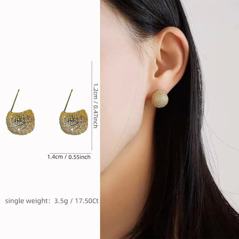 Geometric drop-shaped clip earrings with sphere elements and diamond flashing in gold or white colour