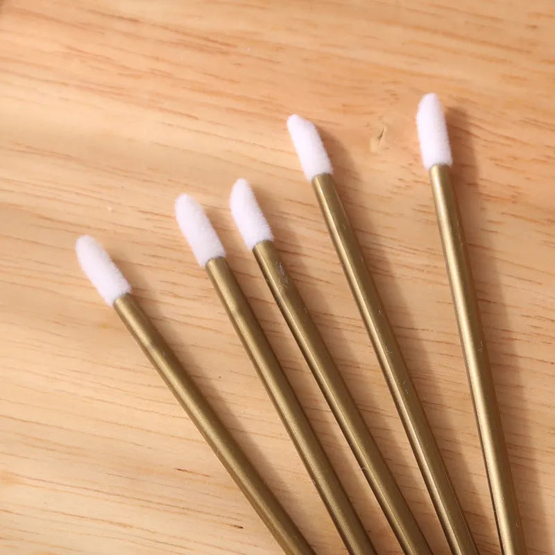 Disposable lip brushes with flocked heads and black handles in various colours
