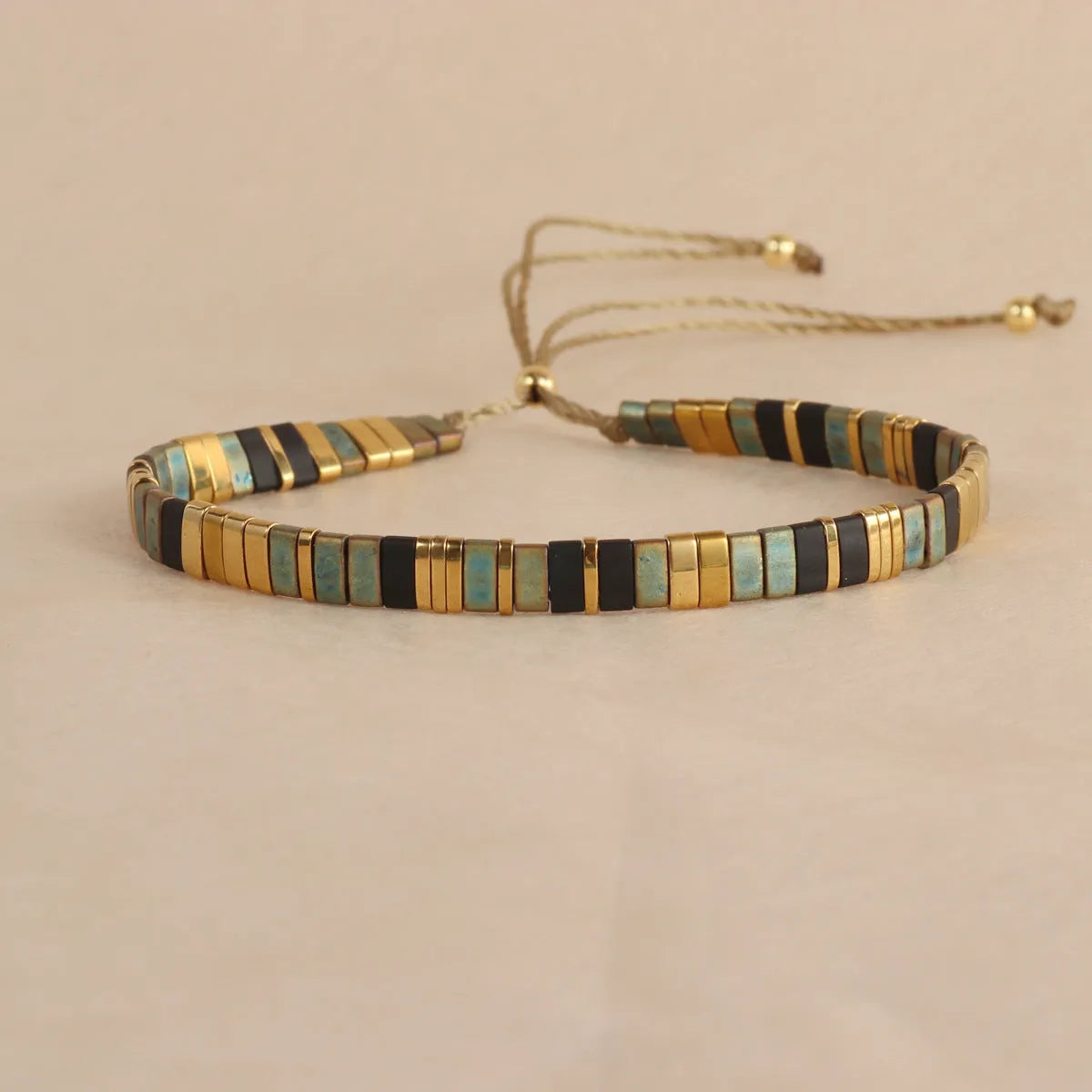 Geometric pull bead bracelet with round glass beads in multiple colour options.