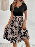 Women's khaki floral print A-line dress with shoulder strap detailing on hanger