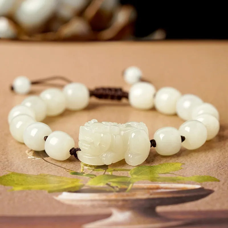Hetian Jade bracelet with a black and red braided rope band and a central jade bead.