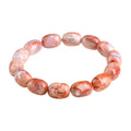 Natural cherry agate bracelet with barrel-shaped beads showing geometric design and Ruyi patterns