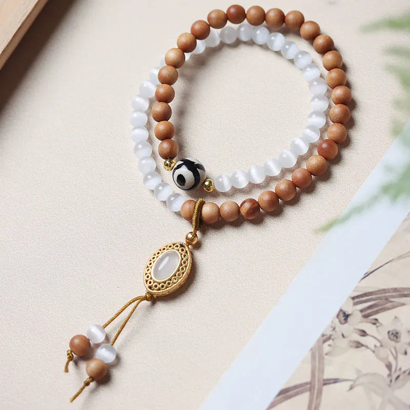 Mixed material bracelet with sandalwood double ring and opal Tibetan beads.