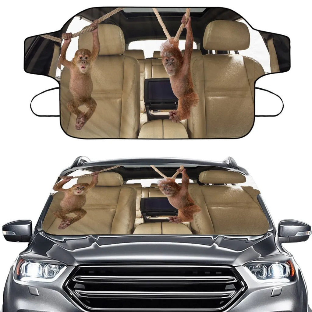 Universal car front snow protection cover made from silver aluminium fabric, shown fitted to a vehicle's windscreen and bonnet.