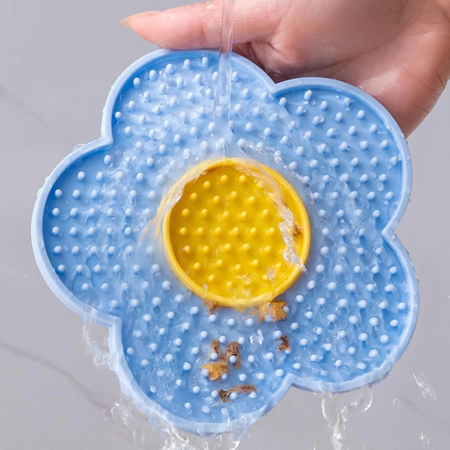 Flower-shaped silicone pet lick mat with suction cups in a choice of colours.