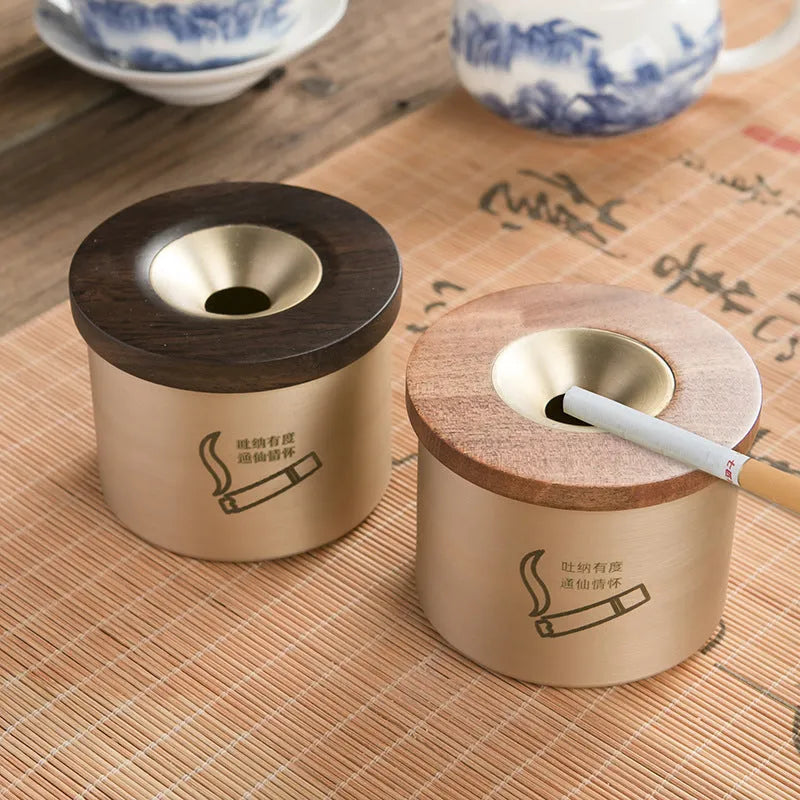 Brass ashtray with wooden lid in copper construction showing centre hole design