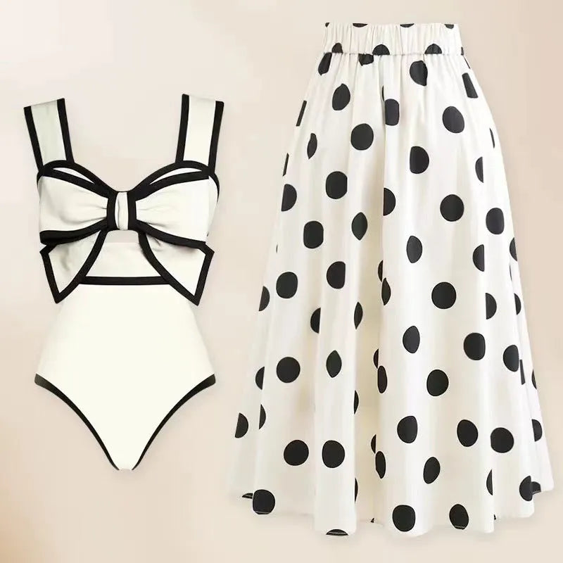 Female one-piece swimsuit with round skirt and bow detail in black or white polyester fabric for swimming and beach wear