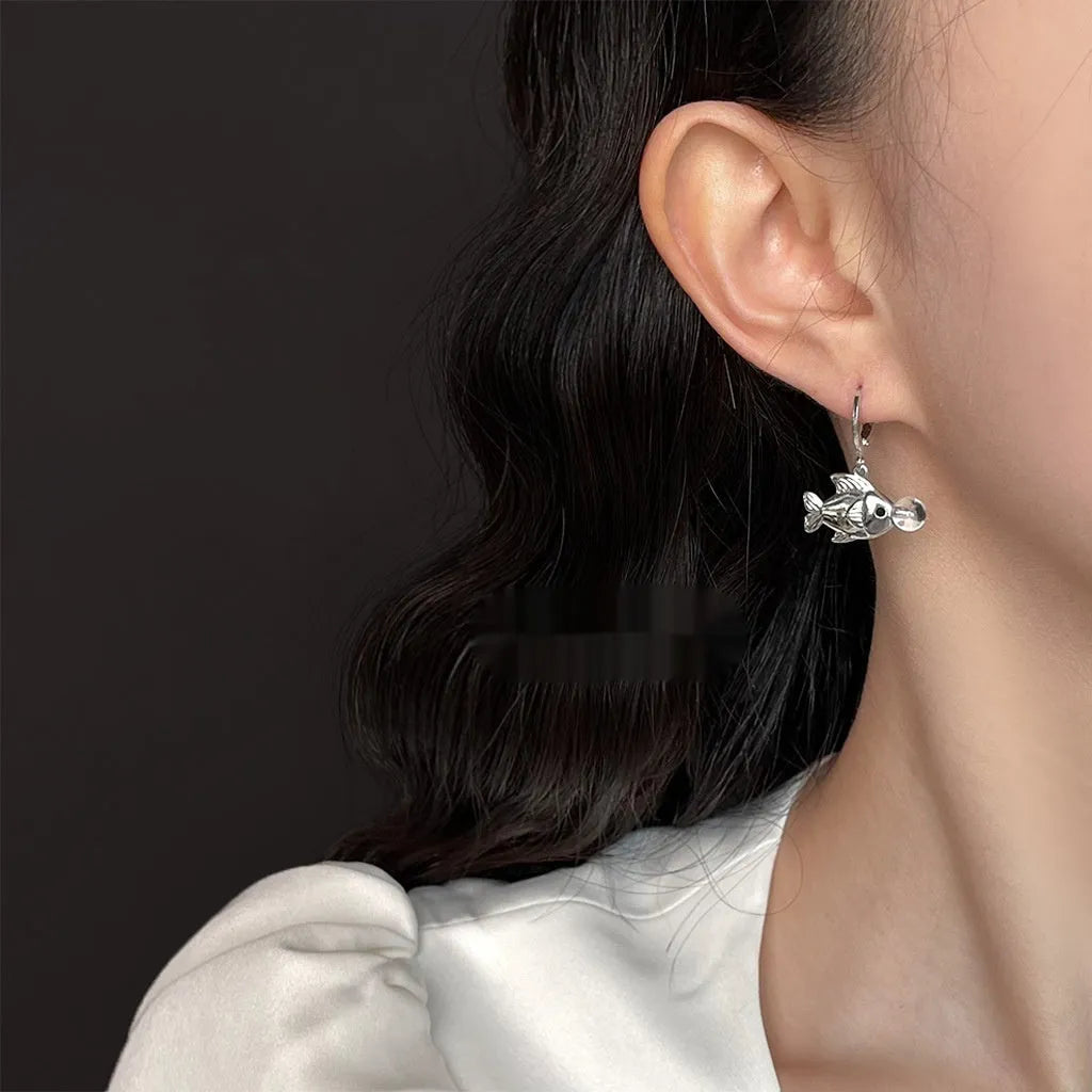 A pair of copper bubble fish earrings with goldfish elements and an electroplated finish.