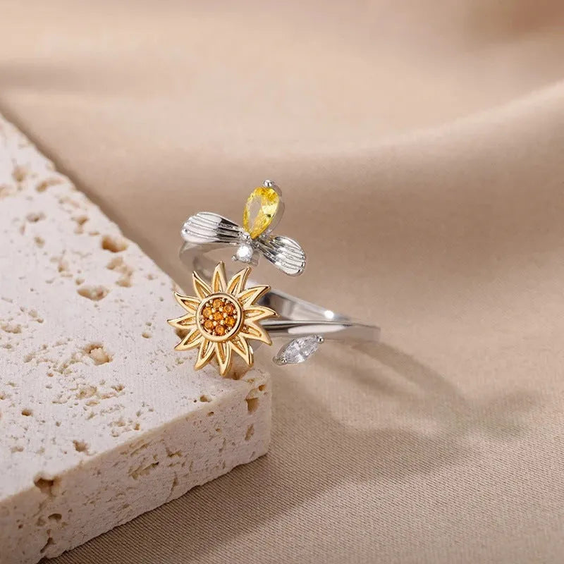 Rotatable decompression ring with adjustable opening in gold electroplated finish