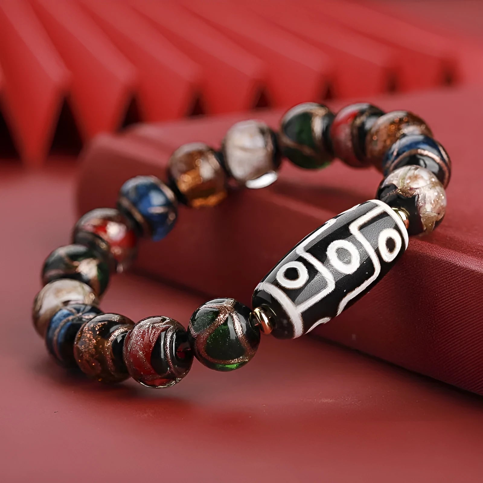 Chinese-style bracelet with colourful glazed beads showing snake patterns, available in 10mm 12mm or 14mm sizes