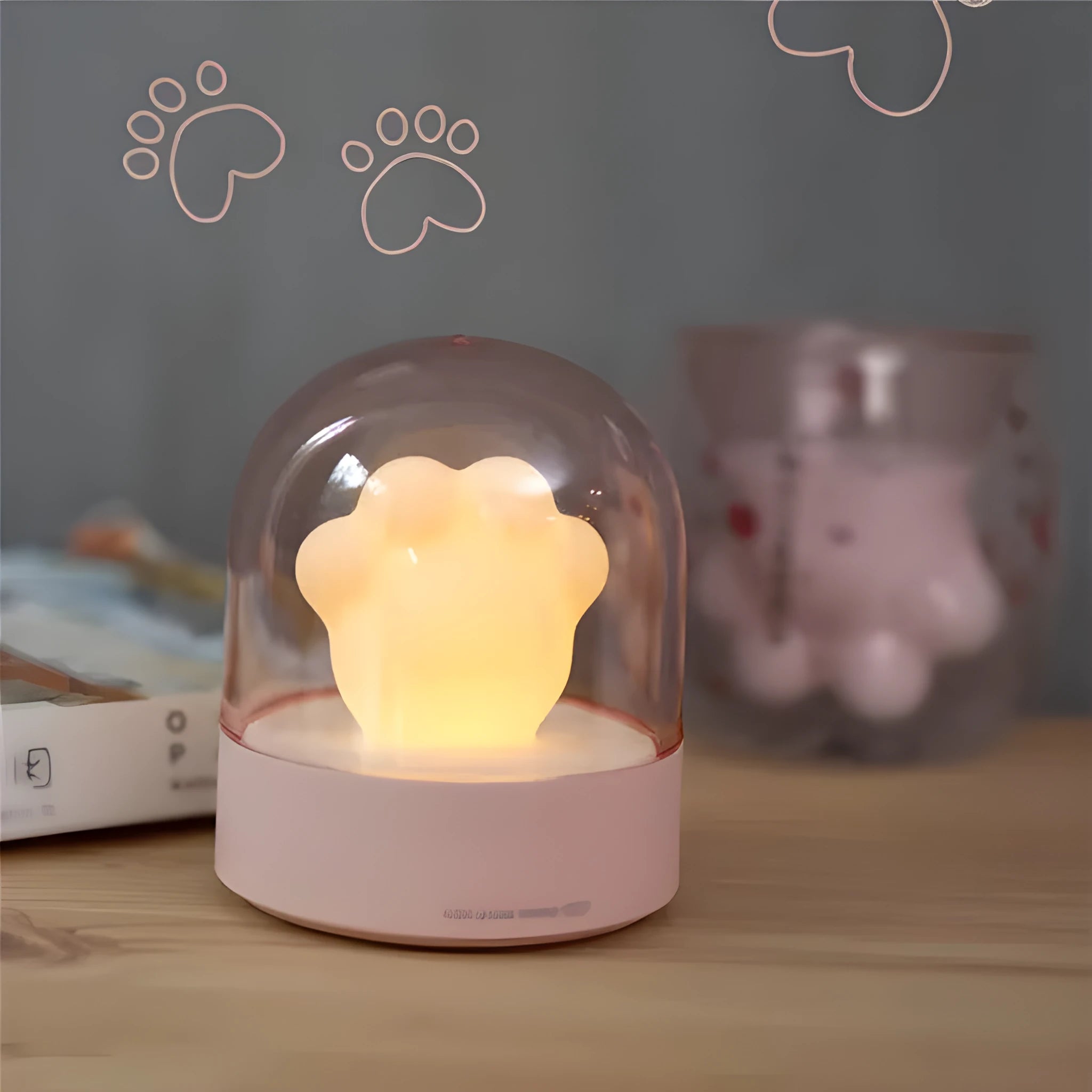 Grey cat paw shaped USB rechargeable night light and music box with soft glowing light.