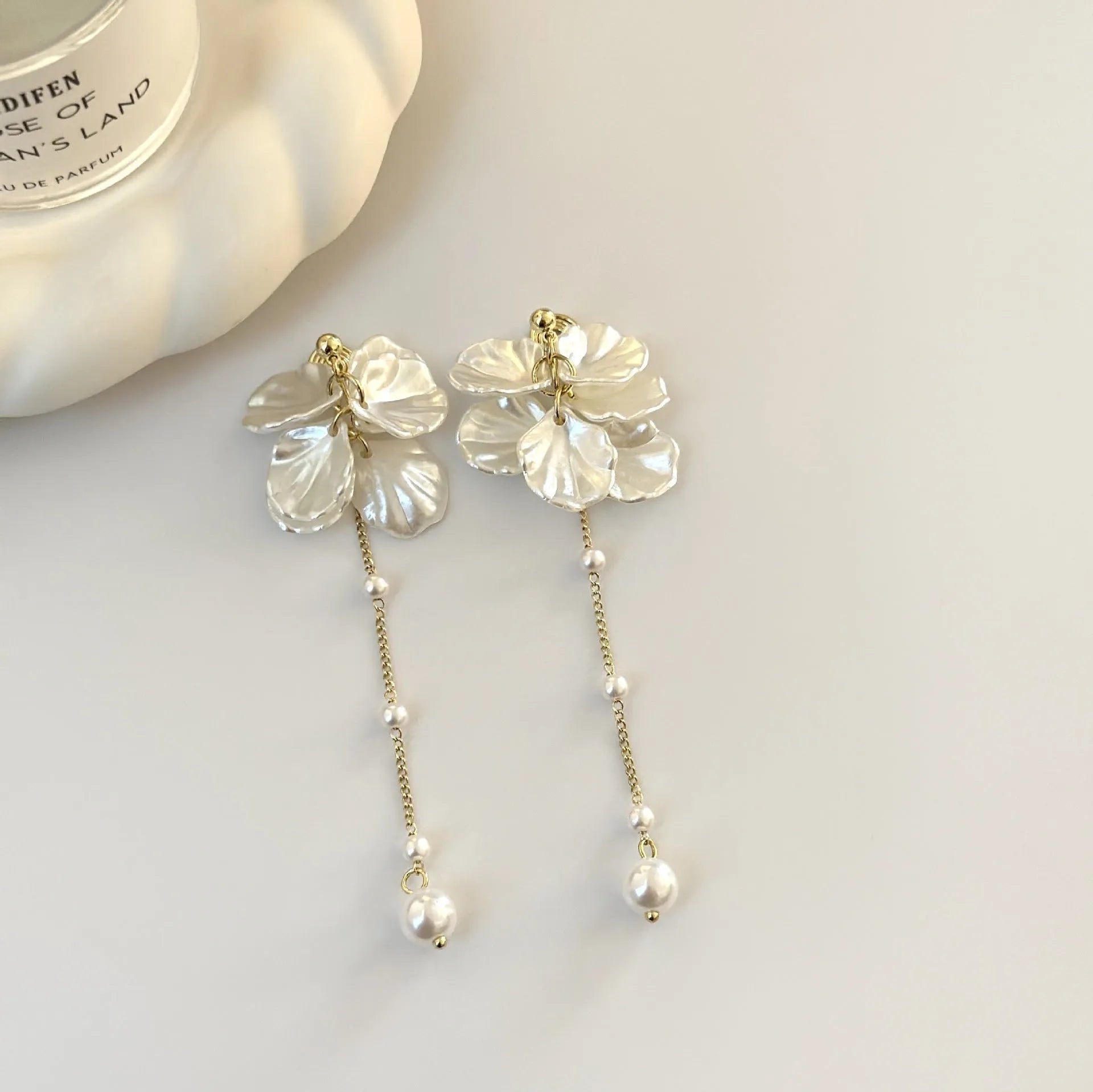Women's acrylic shell pearl tassel earrings showing length, with a choice of four ear clip types.