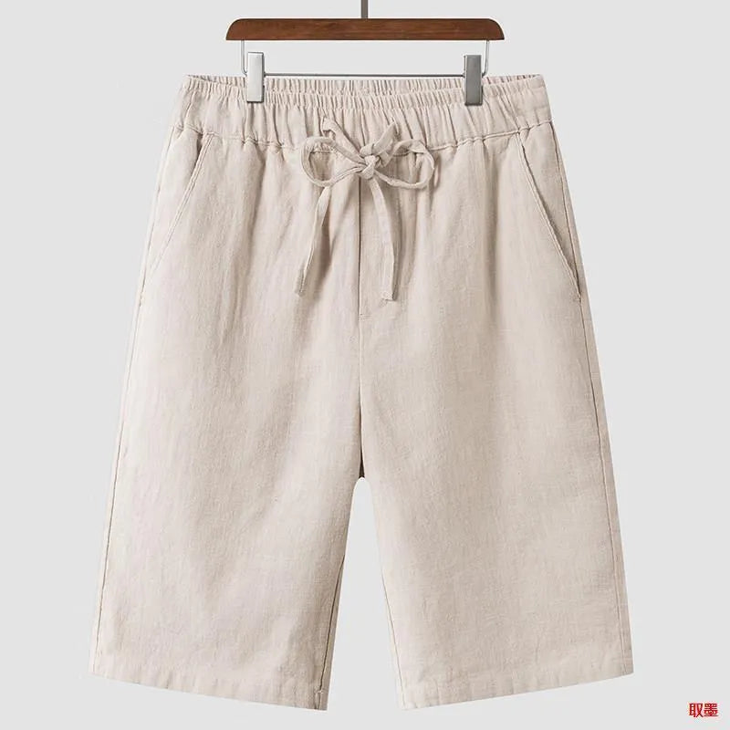 Men's linen shorts in loose cropped design with elastic waistband, shown in available colours
