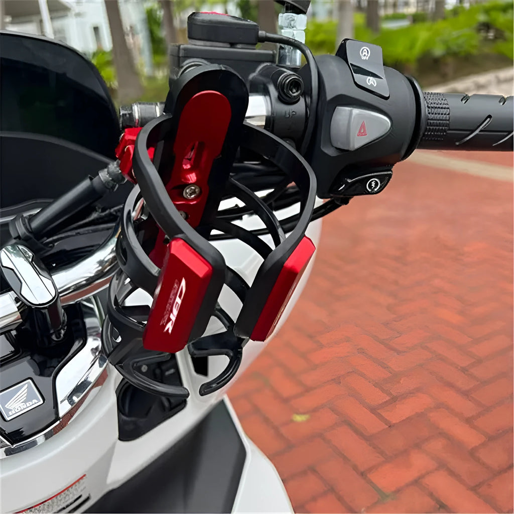 Metal alloy water bottle cage mounted to Honda X-ADV scooter pedal in black finish