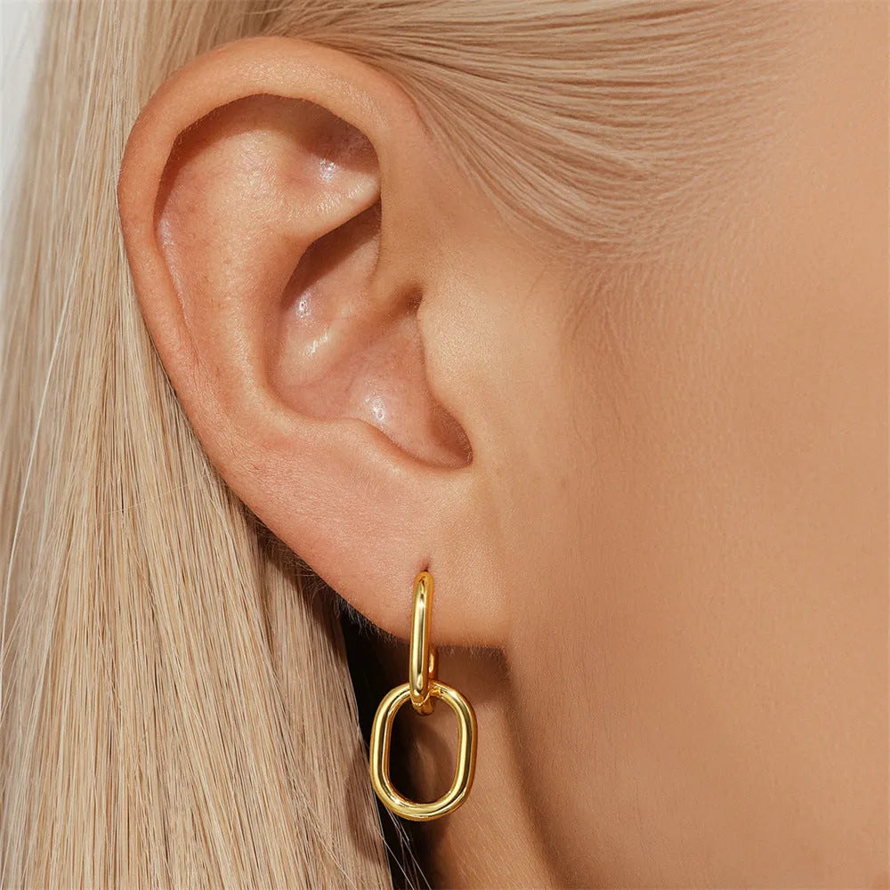 Geometric brass diamond earclip earrings with round accents in golden electroplated finish