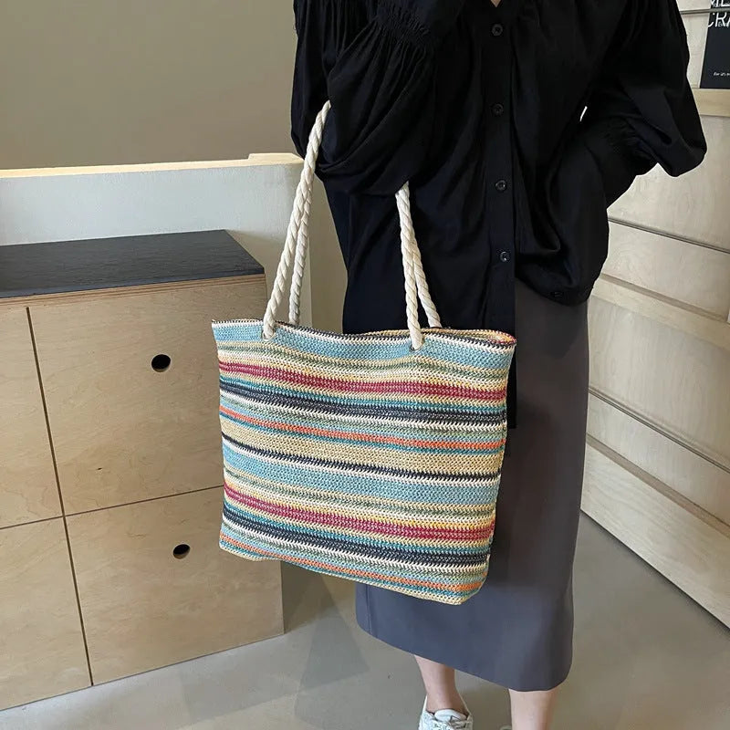 Blue straw woven shoulder bag with single strap showing textured exterior