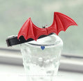 Black patent leather dog collar for small dogs with decorative wings and a bell