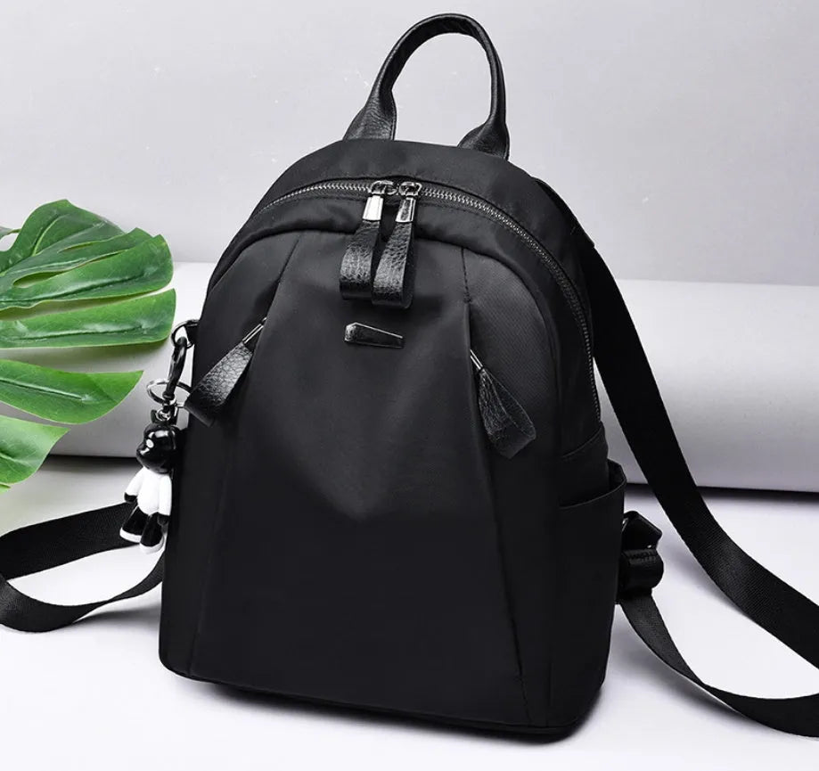 Medium Oxford cloth rucksack showing internal phone and ID compartments with dual straps