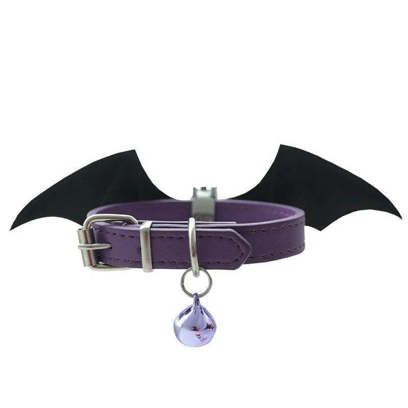 Black patent leather dog collar for small dogs with decorative wings and a bell