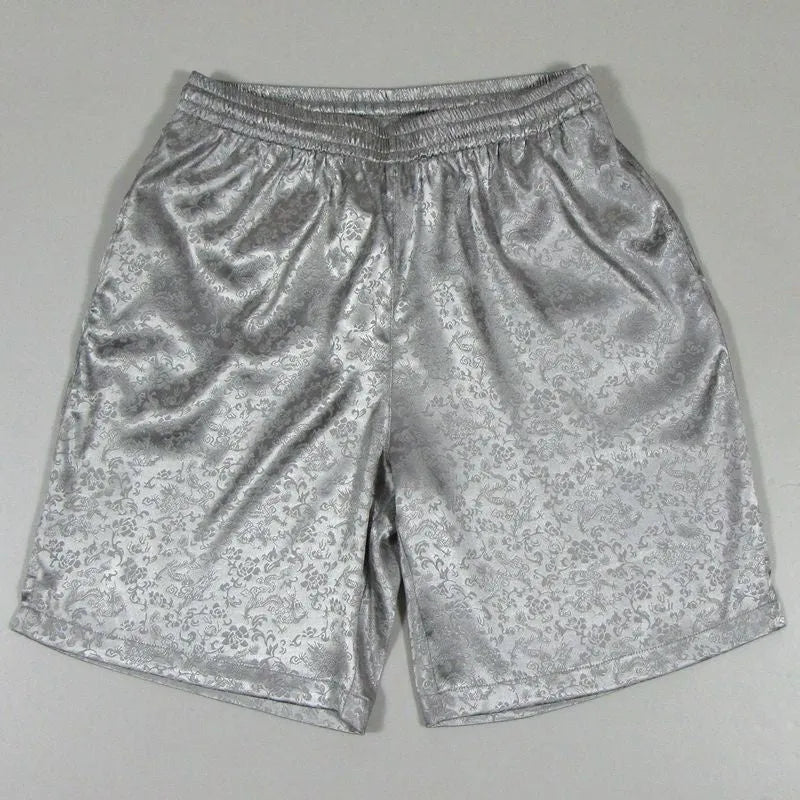 Men's black traditional Tang suit style Tai Chi shorts with an elastic drawstring waistband laid flat.