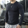 Man wearing black slim-fit long sleeve fitness tights for running or gym workout