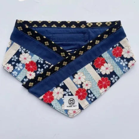 Japanese style pet scarf bib with red diamond pattern and tassels on a light background