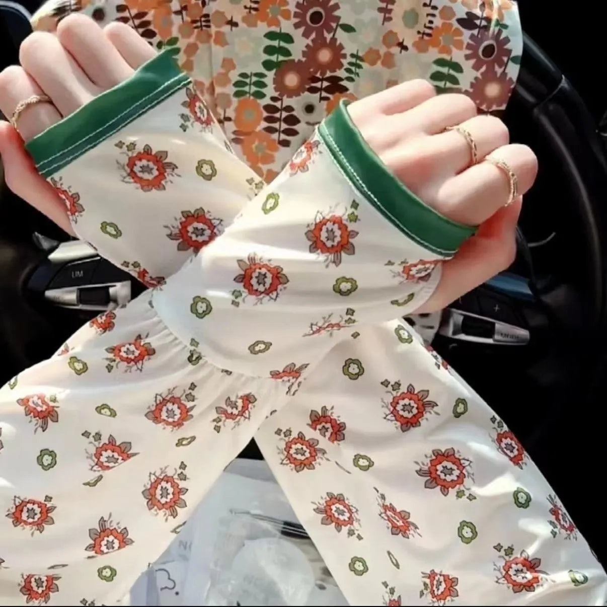 A pair of printed viscose ice silk sun protection sleeve gloves covering the forearm and elbow.