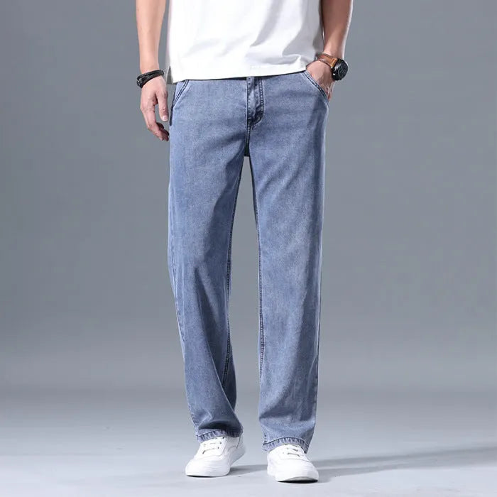 Men's loose fit straight leg lyocell jeans in light blue on a neutral background.