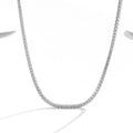 Women's sterling silver necklace with round pendant, diamond treatment finish