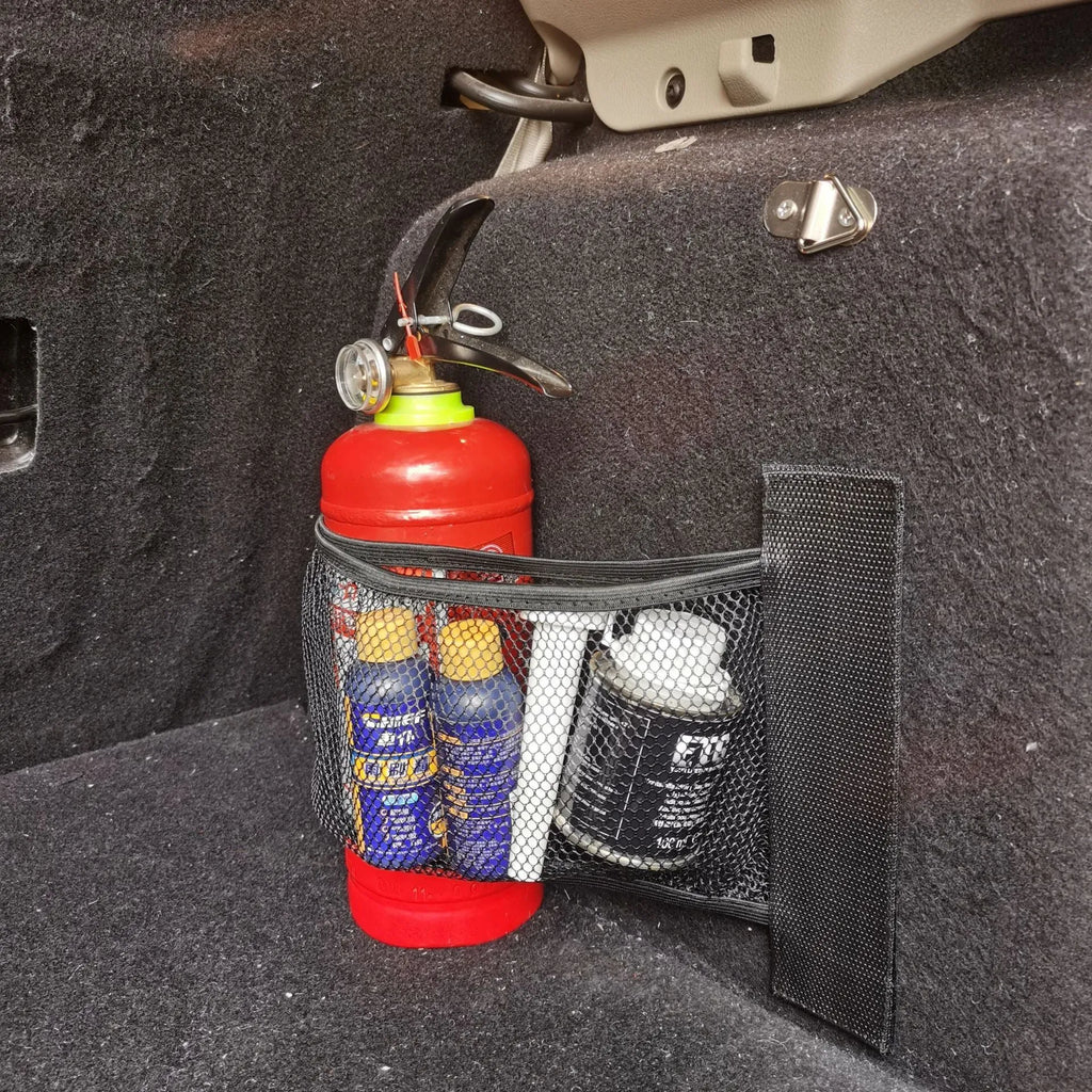Elastic car boot storage net organiser holding various loose items securely in place